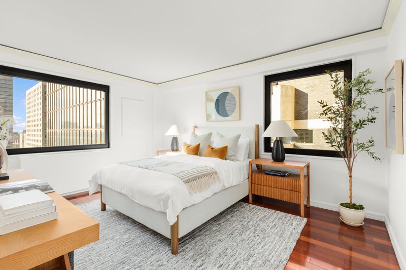 Bedroom with skyline windows at 10 West 66th Street 29E, Lincoln Square — photo 7 of 9