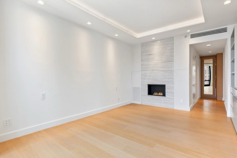 primary bedroom empty, marble fireplace