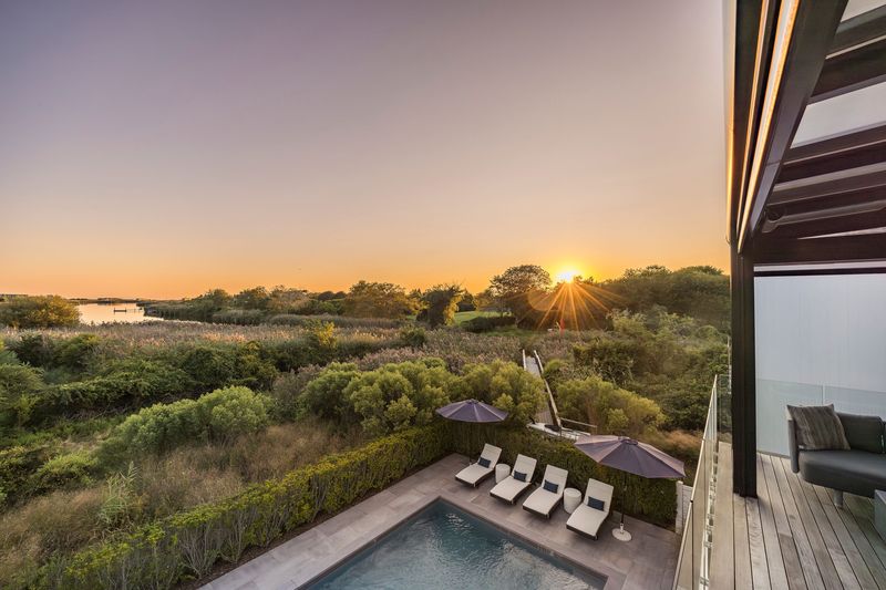 Sunset over marsh and pool at 1076 Ocean Road, Bridgehampton