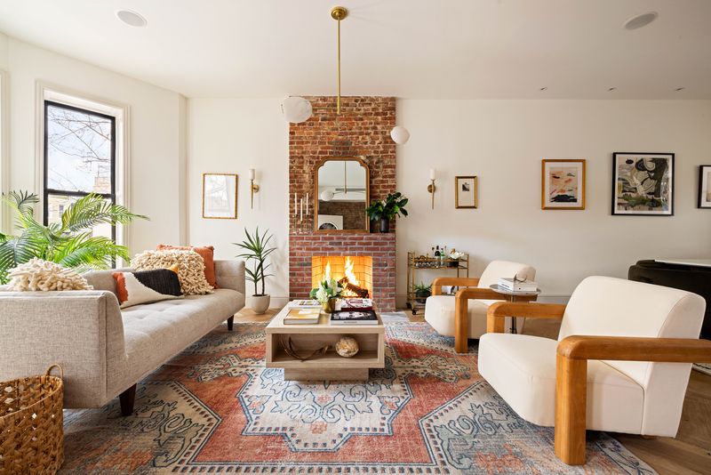 Parlor living room with a brick fireplace at 1102 Prospect Place, Crown Heights