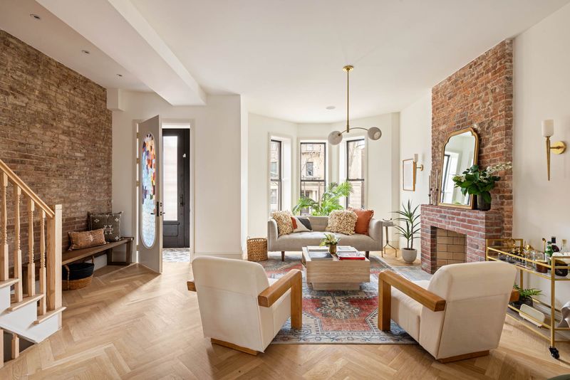 Parlor floor with exposed brick and herringbone floors at 1102 Prospect Place, Crown Heights — photo 5 of 9