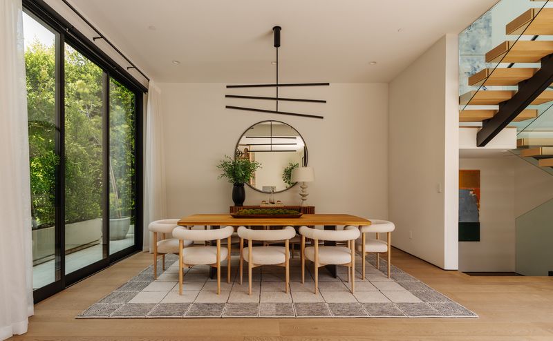 Dining by floating staircase at 116 S Gretna Green Way, Brentwood — photo 5 of 10