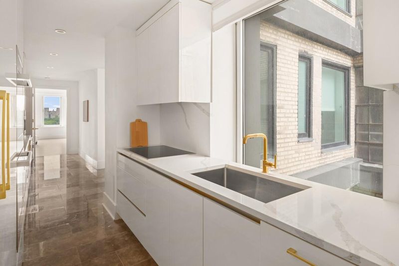Kitchen galley toward the windows at 1200 Fifth Avenue 15A, Carnegie Hill — photo 5 of 13