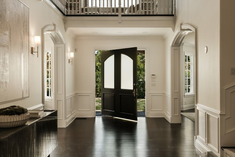 Double-height foyer with gallery landing at 1228 Amalfi Drive, Pacific Palisades — photo 5 of 12
