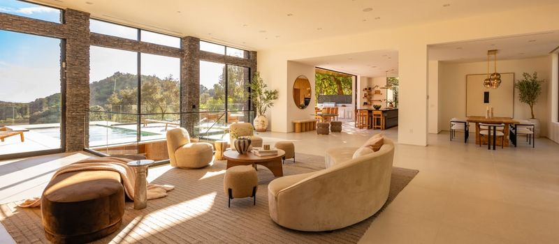 Living area flowing to the dining room at 12752 Mulholland Drive, Beverly Hills — photo 5 of 8