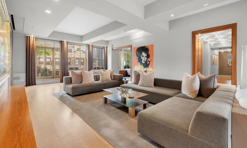 Great room with sectional under a coffered ceiling at 130 West 30th Street 18A, Chelsea / NoMad