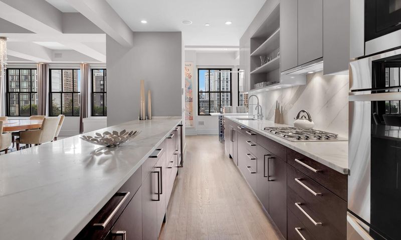 Kitchen with white stone counters at 130 West 30th Street 18A, Chelsea / NoMad — photo 3 of 8
