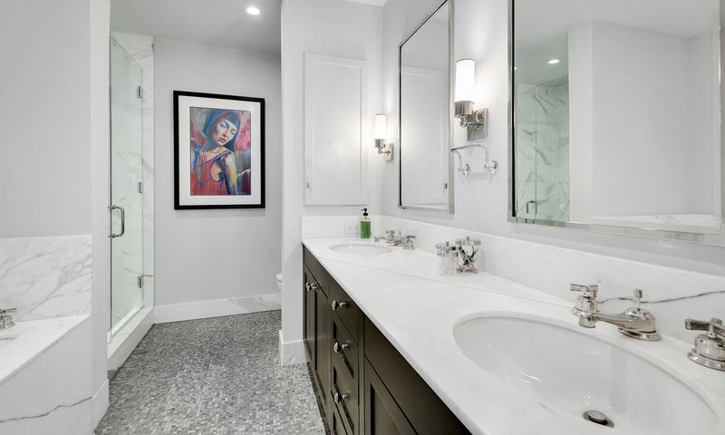 Primary bath with double vanity at 130 West 30th Street 18A, Chelsea / NoMad — photo 8 of 8