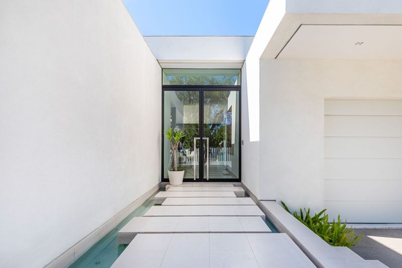 Glass entry over the water feature at 1535 Carla Ridge, Trousdale Estates — photo 5 of 10
