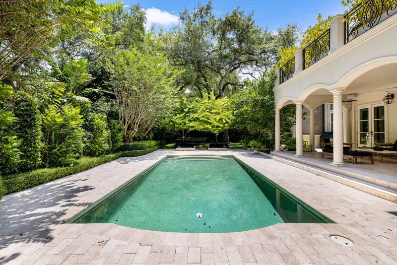 Pool and limestone deck with covered terrace at 155 San Souci Drive, Coral Gables — photo 2 of 9