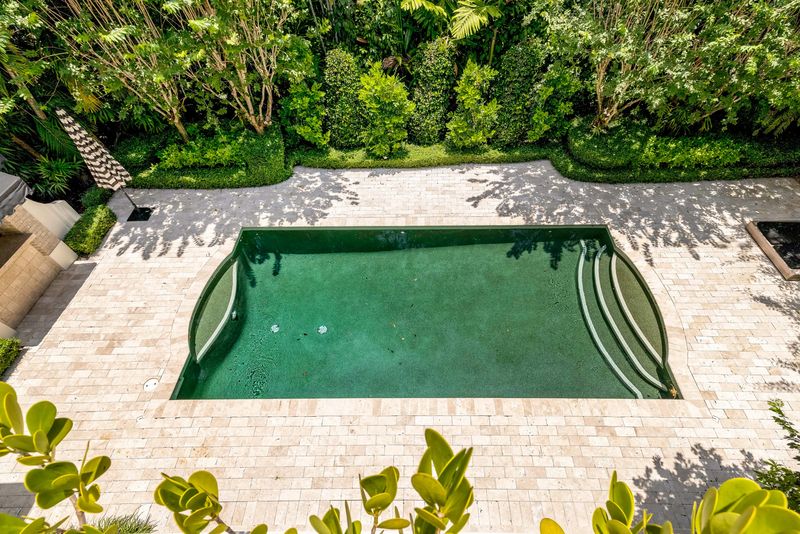 Aerial view of the pool and limestone deck at 155 San Souci Drive, Coral Gables — photo 3 of 9