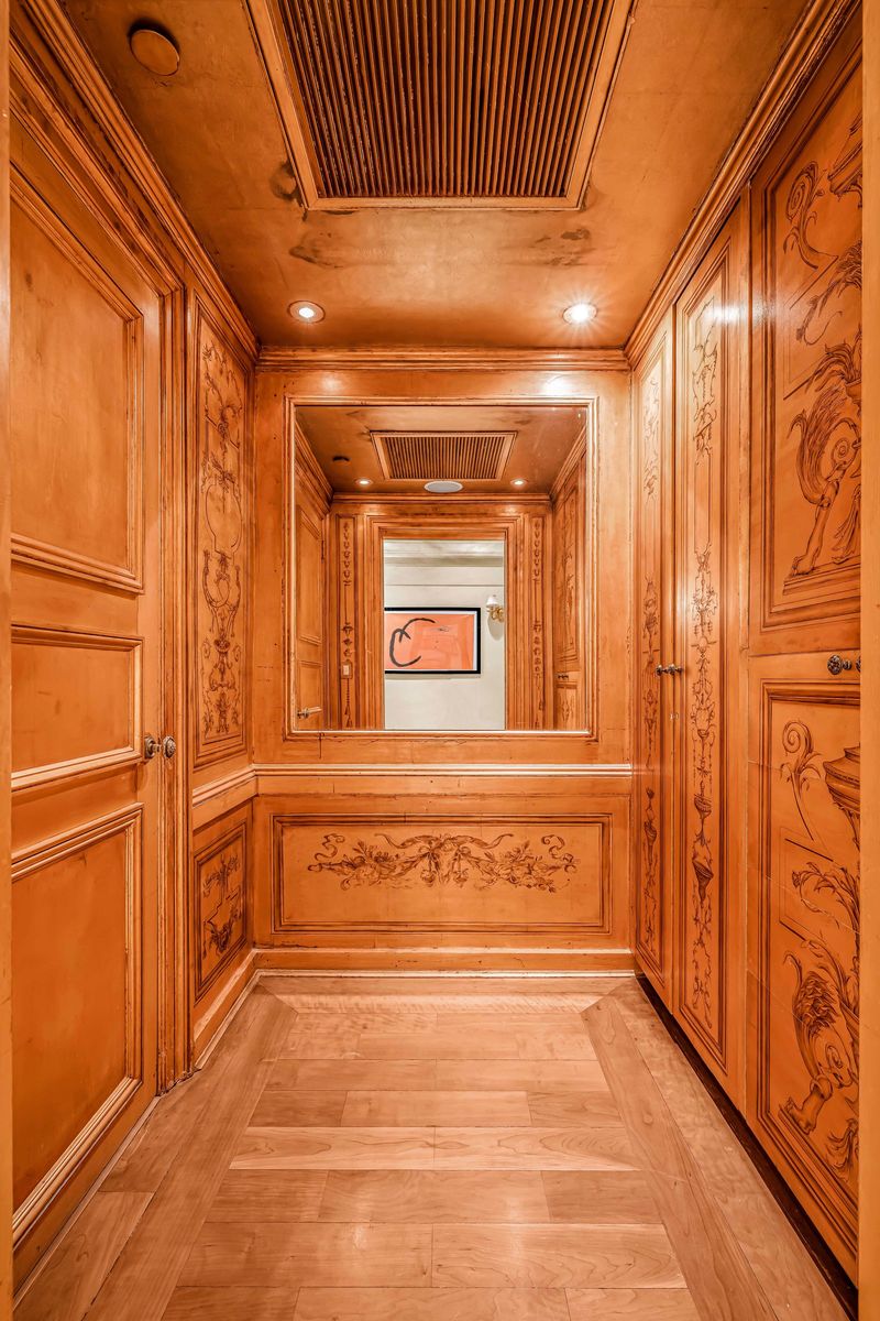 Wood-paneled passage with carved floral panels at 160 Central Park South 915, Central Park South — photo 5 of 6