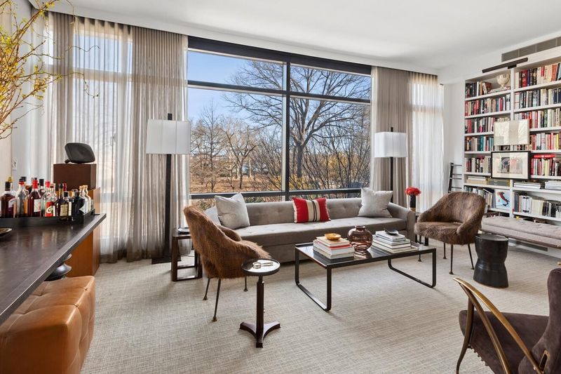 Living room with floor-to-ceiling windows over Carl Schurz Park at 170 East End Avenue 3J, Upper East Side