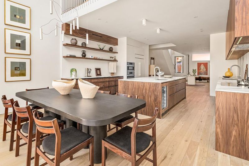 Kitchen and dining room under a double-height opening at 172 North 6th Street, Williamsburg