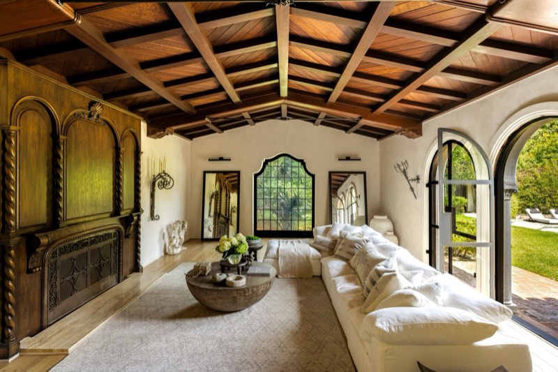 living / paneled cabinet / beamed ceiling