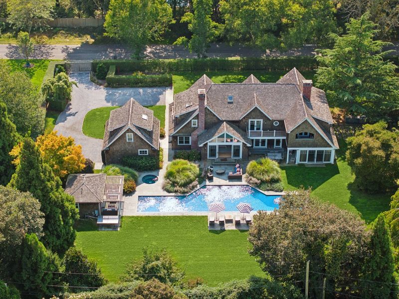 Aerial of the shingle estate, pool, spa and lawn at 2 Borden Lane, East Hampton