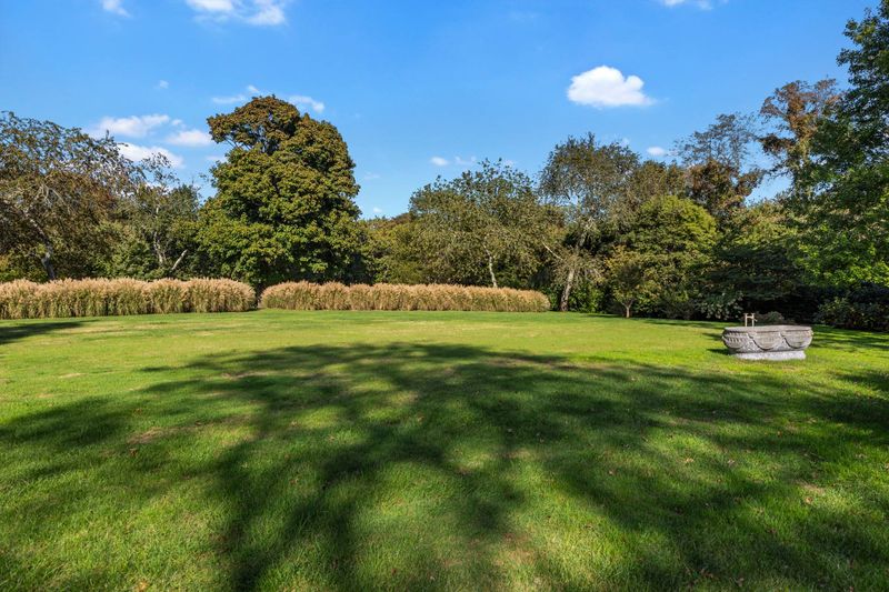 Rolling lawn and hedgerow at 216 Sagaponack Road, Bridgehampton — photo 12 of 12