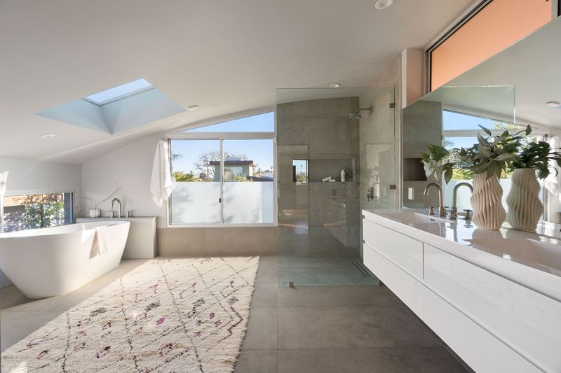 Spa-like primary bath with a freestanding tub under a skylight at 2324 Boone Avenue, Venice — photo 5 of 8