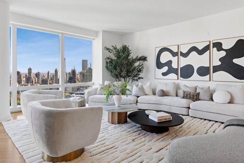 Living room with sculptural lounge chair at 25 Columbus Circle 57B, Columbus Circle — photo 3 of 8
