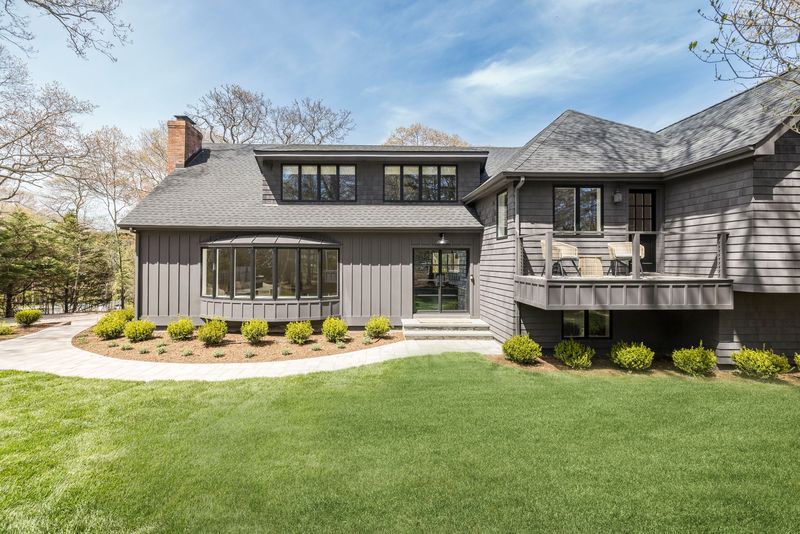 The renovated shingled house and front lawn at 25 White Oak Lane, Southampton