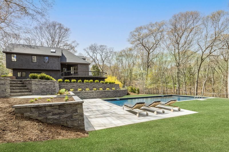 New heated saltwater pool and stone terracing at 25 White Oak Lane, Southampton — photo 2 of 10