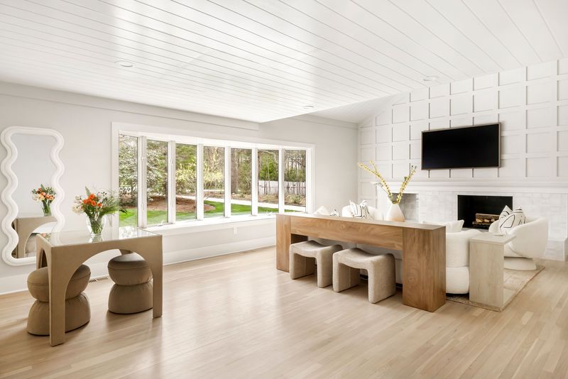Great room with a paneled fireplace wall at 25 White Oak Lane, Southampton — photo 3 of 10