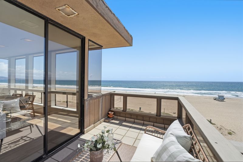 Balcony seating overlooking the sand and pier at 2516 The Strand, Manhattan Beach — photo 3 of 8