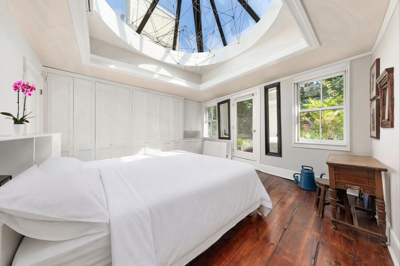 Primary bedroom under a round skylight at 264 West 12th Street, West Village — photo 5 of 9