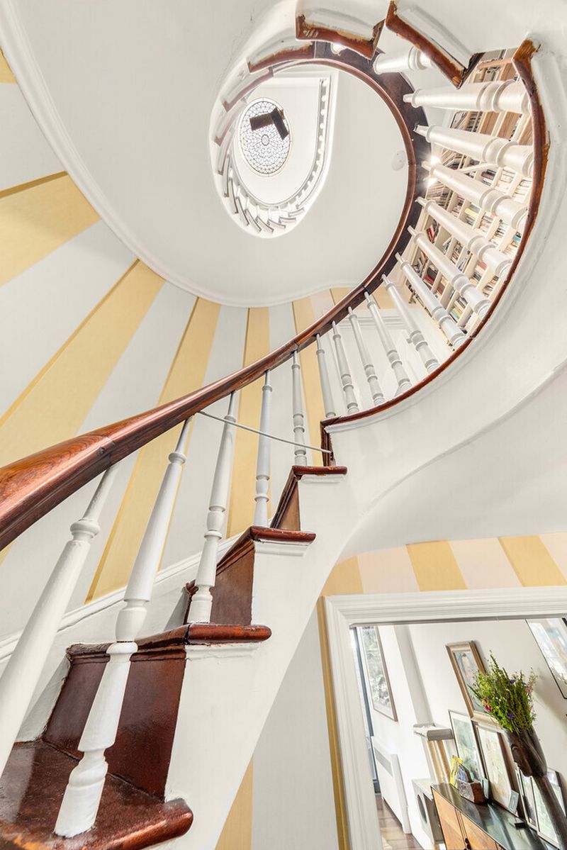Spiral staircase toward the skylight at 264 West 12th Street, West Village — photo 9 of 9