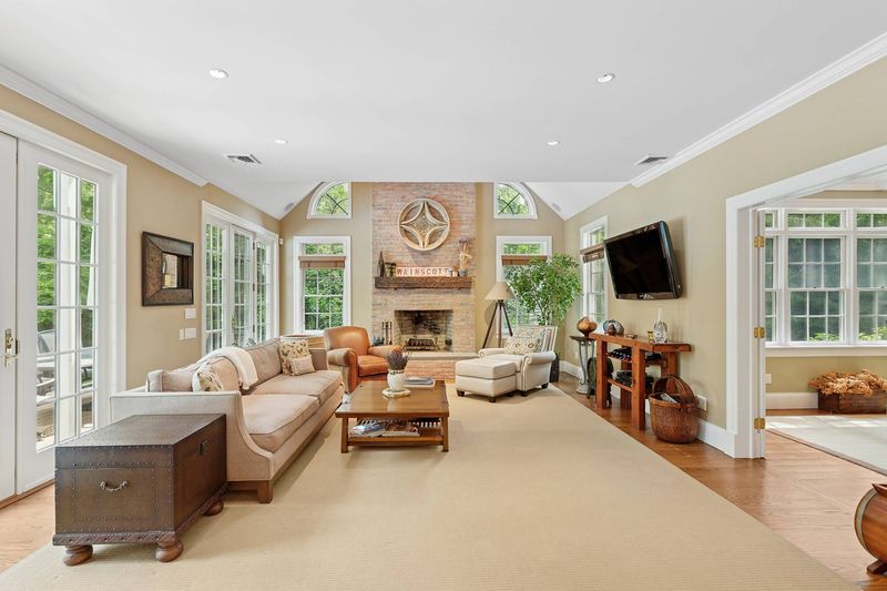 Great room cathedral ceiling, brick fireplace at 3 Whitney Lane, Wainscott — photo 2 of 8