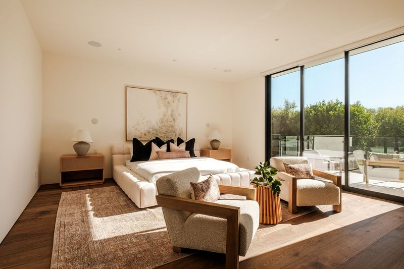 Primary bedroom with garden views at 317 South Wetherly Drive, Beverly Hills — photo 8 of 9