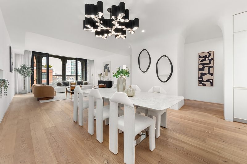 Dining area with living room beyond at 325 West Broadway 7B, SoHo — photo 2 of 13