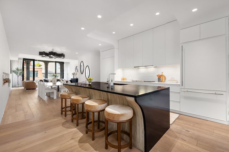 Kitchen with Black Saint Laurent marble island at 325 West Broadway 7B, SoHo — photo 3 of 13