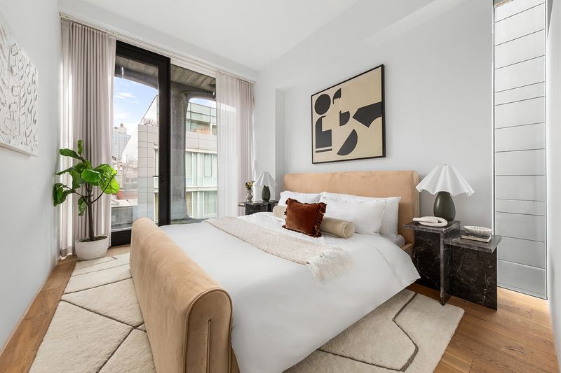 Bedroom with upholstered bed at 325 West Broadway 7B, SoHo — photo 10 of 13