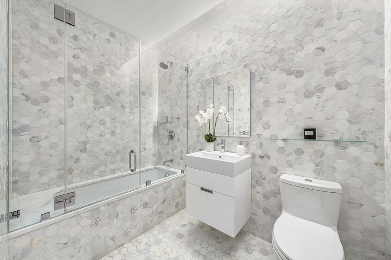 Bath with tub and marble tile at 325 West Broadway 7B, SoHo — photo 12 of 13