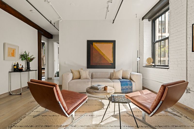 Living area with corner windows at 33 Bleecker Street 3B, NoHo — photo 2 of 9