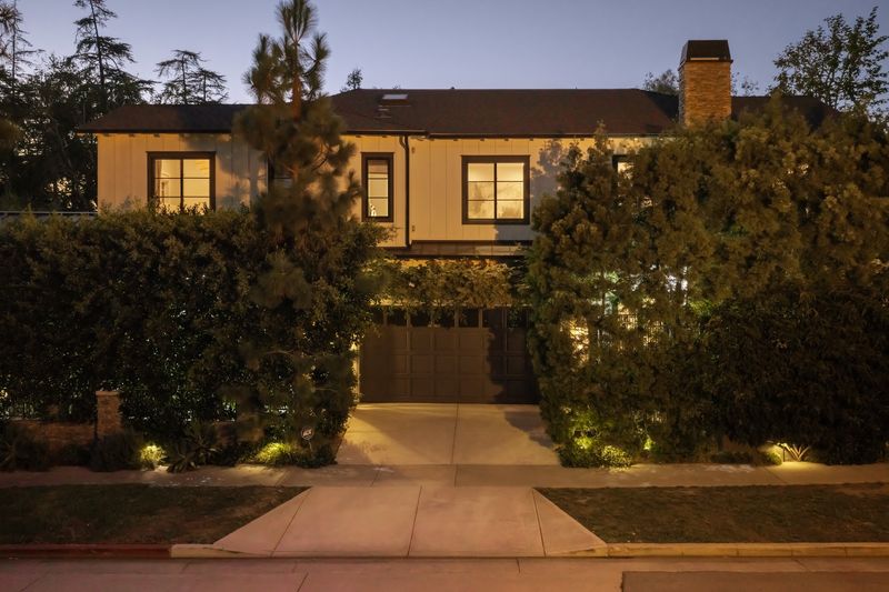 Street front at dusk behind tall clipped hedges at 371 20th Street, Santa Monica