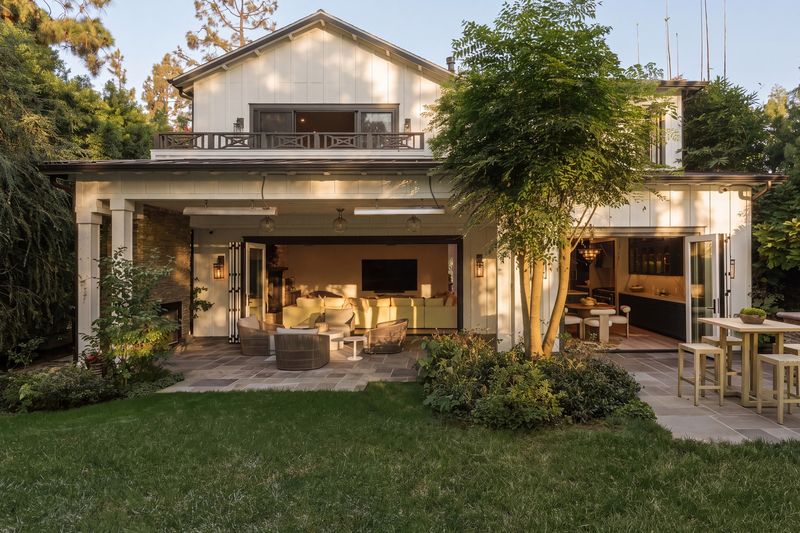 Backyard at dusk with covered patio and lawn at 371 20th Street, Santa Monica — photo 2 of 8