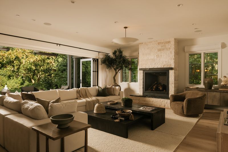 Family room with stone fireplace open to the garden at 371 20th Street, Santa Monica — photo 4 of 8
