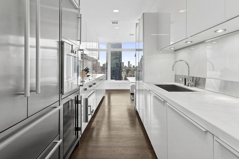 Windowed galley kitchen with city view at 400 East 67th Street 27A, Lenox Hill — photo 3 of 8