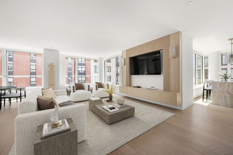 Living room with oak media wall and courtyard outlook at 450 Washington Street 520, Tribeca