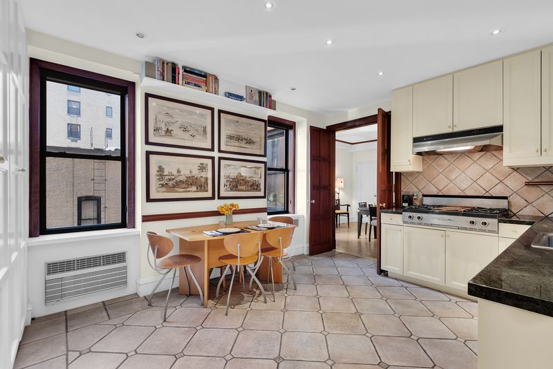 Windowed eat-in kitchen with a dining table at 55 East 86th Street 8B, Carnegie Hill — photo 3 of 9