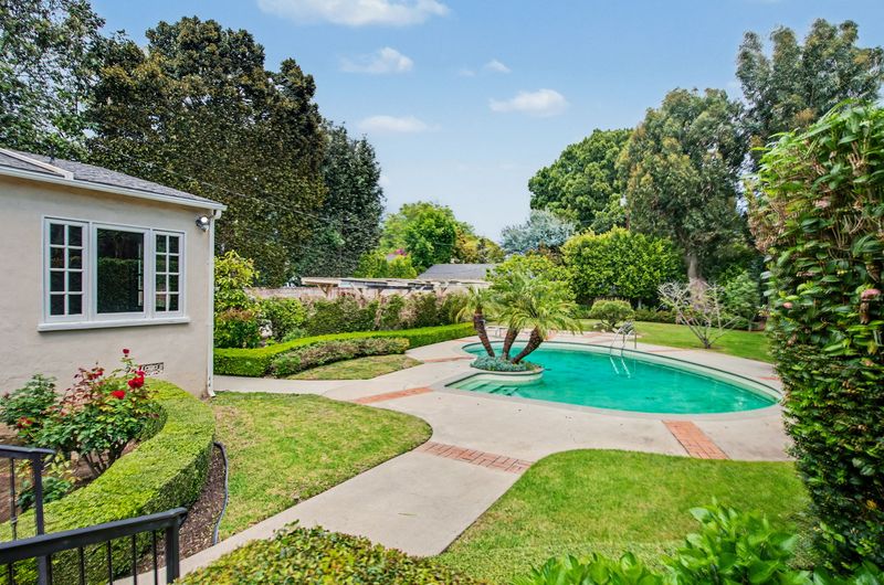 Pool and palms in the hedged backyard at 608 Trenton Drive, Beverly Hills Flats — photo 4 of 10