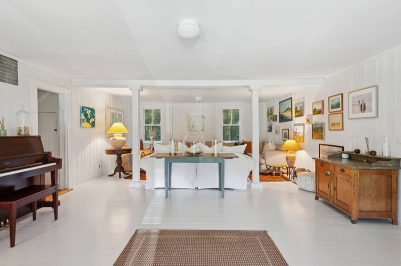 Living room with piano and garden light at 645 North Sea Mecox Road, Southampton — photo 6 of 12