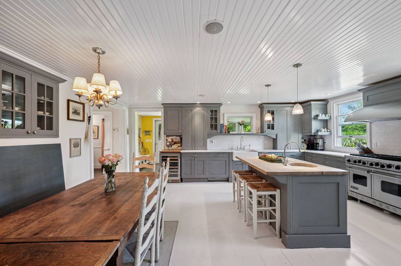 Chef's kitchen with professional range and center island at 645 North Sea Mecox Road, Southampton — photo 7 of 12