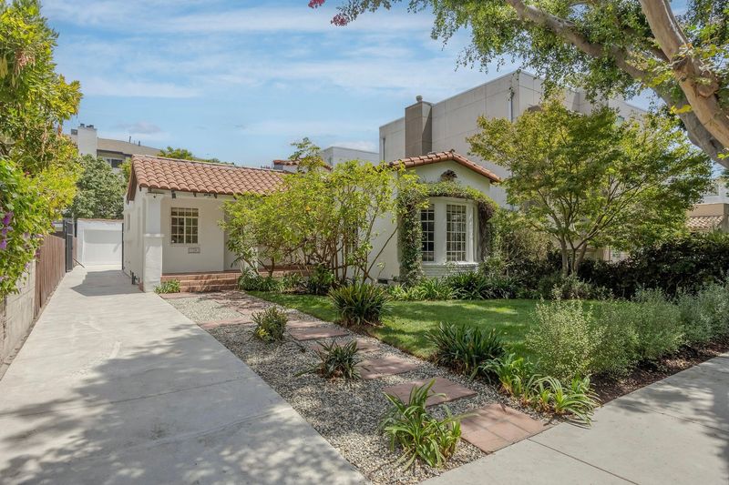 The restored Spanish facade behind a garden path at 718 Westbourne Drive, West Hollywood — photo 3 of 5