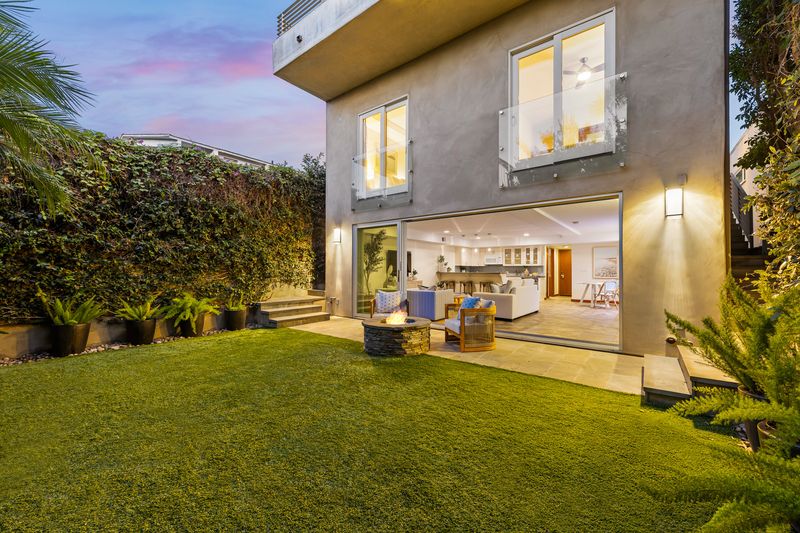 Rear of the house at dusk over the backyard at 721 12th Street, Manhattan Beach