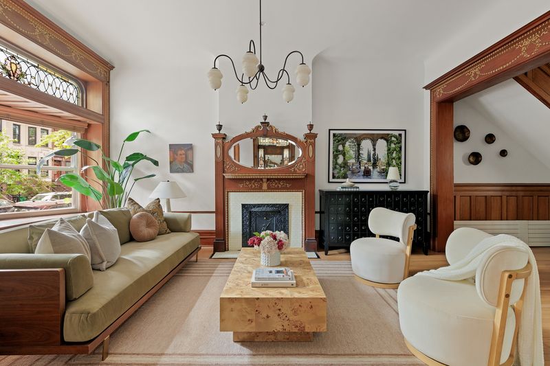 Parlor living room with stained-glass transom and carved mantel at 8 Polhemus Place, Park Slope