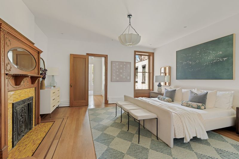 Primary bedroom with carved mantel at 8 Polhemus Place, Park Slope — photo 7 of 12