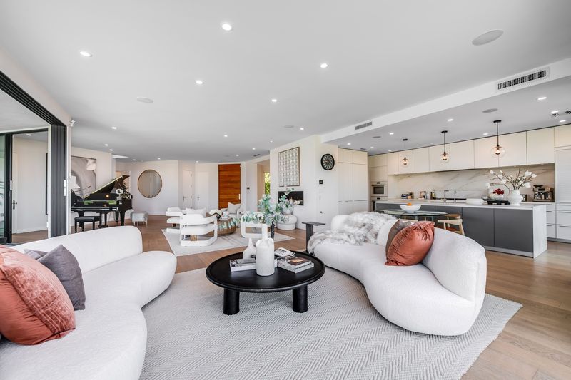 Great room with grand piano and open kitchen at 8545 Charl Lane, Hollywood Hills — photo 5 of 8